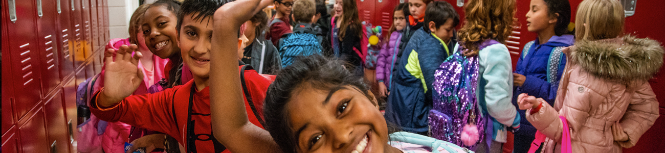 Students in hallway waving  